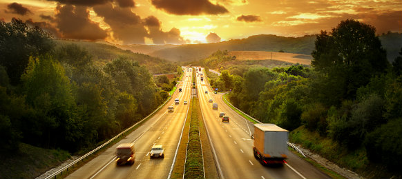 cars in the highway under the sunset