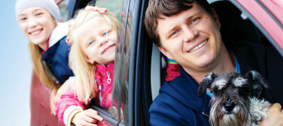 family with a dog in the car rental