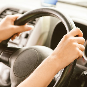 Hands on the steering wheel of the car