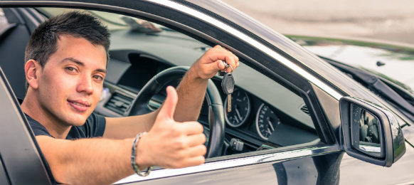 dapper guy posing showing his car key